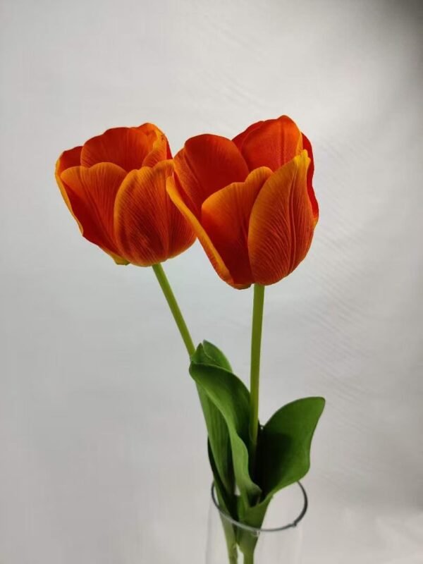 two artificial real touch orange tulips